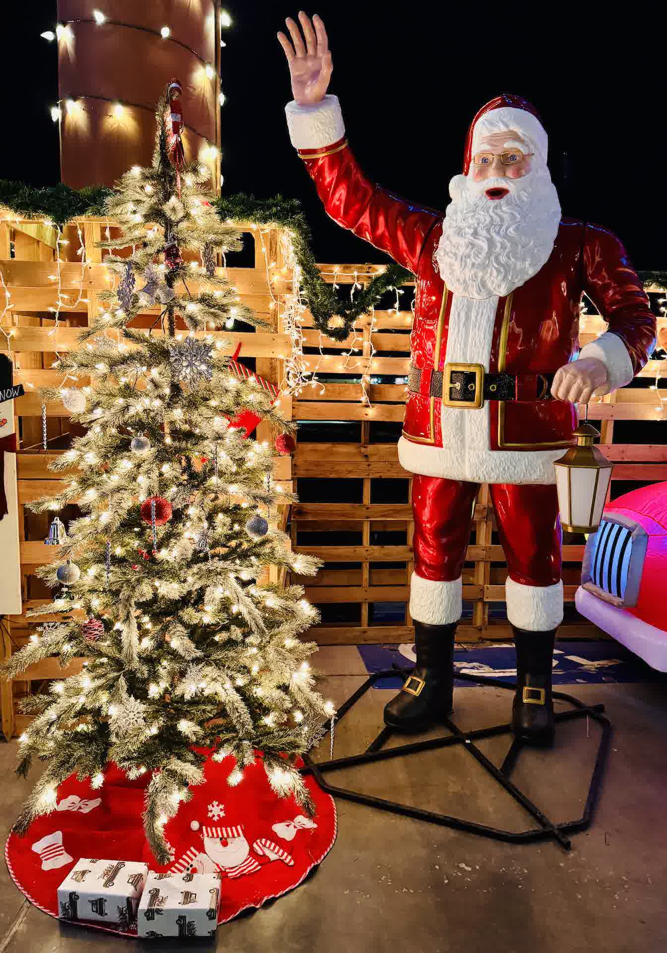 A lit-up Christmas photo spot with Santa